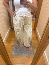 POL Designed in high rise wide pants in denim/twill with lace on top patch, outseam detail, floral metal button detail, solid color - Oatmilk.