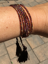 Six strand faceted metallic ab finish crystal beaded adjustable bracelet.