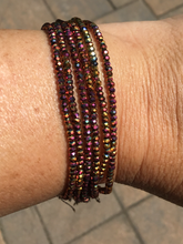 Six strand faceted metallic ab finish crystal beaded adjustable bracelet.